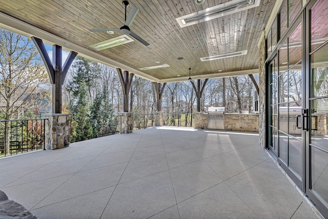 view of patio featuring area for grilling and ceiling fan