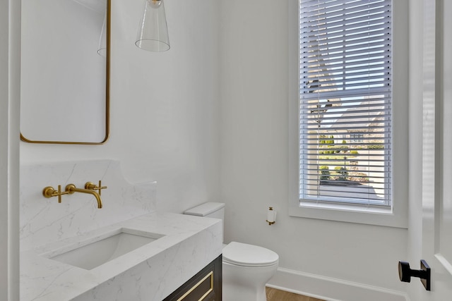 bathroom featuring vanity and toilet