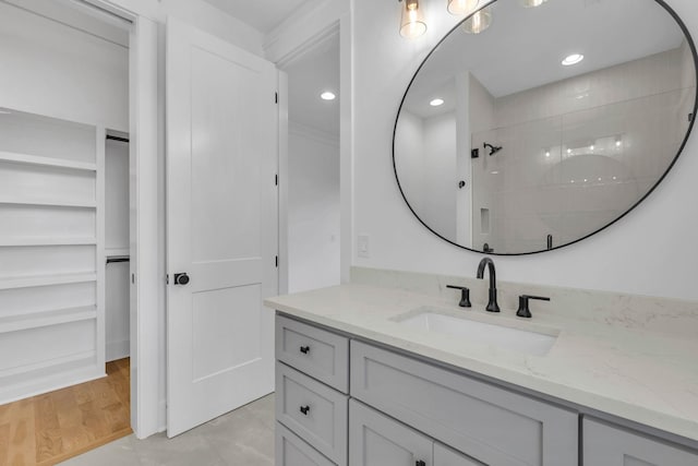 bathroom with vanity, wood-type flooring, and walk in shower