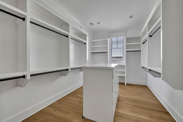 walk in closet featuring light hardwood / wood-style flooring