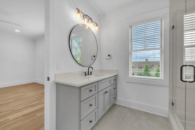 bathroom with vanity and a shower with door