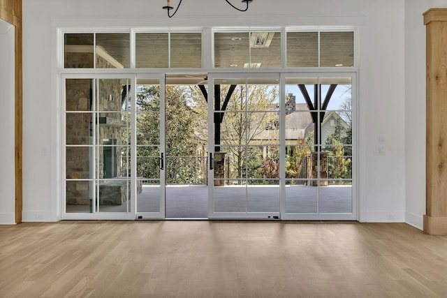 doorway with hardwood / wood-style flooring