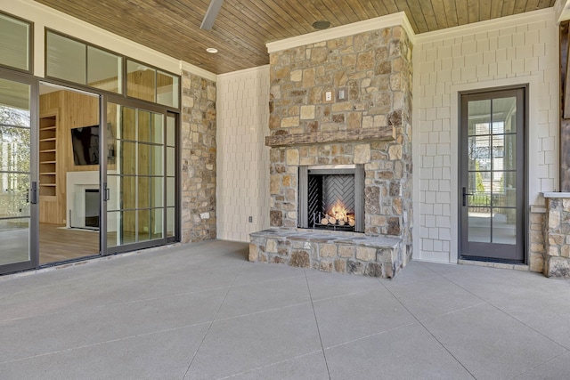 unfurnished living room featuring a fireplace, wooden ceiling, and a high ceiling