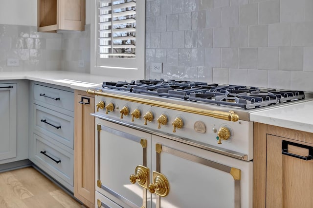 kitchen with tasteful backsplash and light brown cabinetry