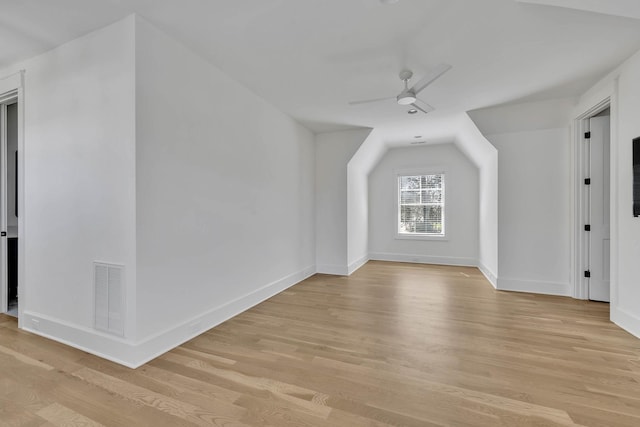 additional living space featuring lofted ceiling, light hardwood / wood-style flooring, and ceiling fan