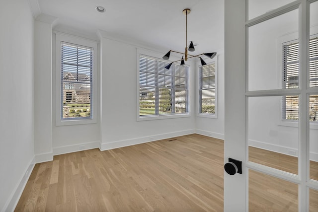 empty room featuring hardwood / wood-style flooring and ornamental molding