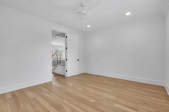 unfurnished room featuring ornamental molding, ceiling fan, and light wood-type flooring