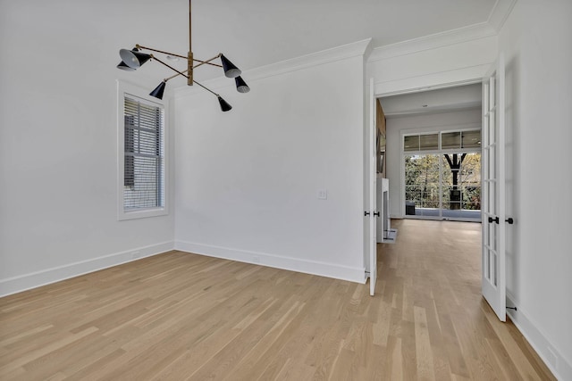 unfurnished room featuring ornamental molding and light wood-type flooring