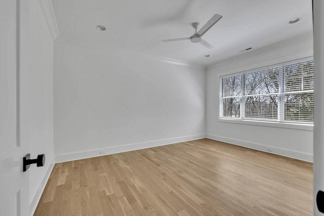 empty room with crown molding, ceiling fan, and light hardwood / wood-style floors