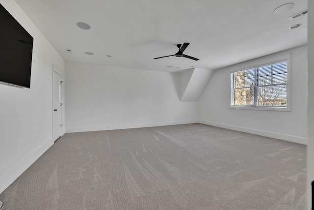 additional living space featuring light carpet and ceiling fan