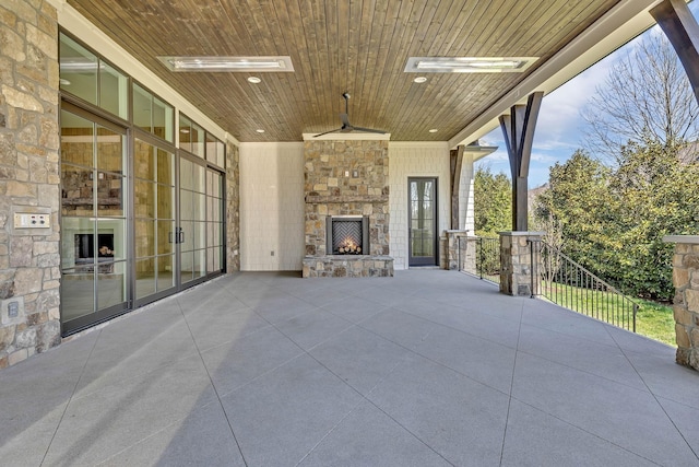 view of patio with an outdoor stone fireplace