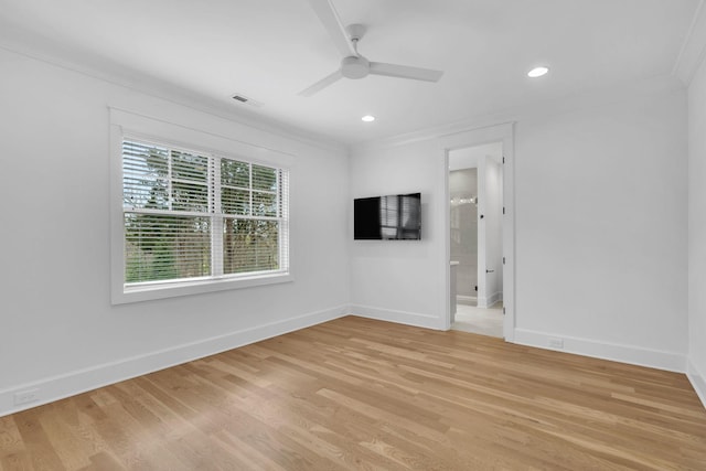 empty room with crown molding, ceiling fan, and light wood-type flooring