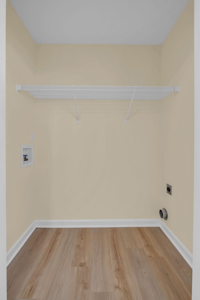 clothes washing area featuring hookup for a washing machine, wood-type flooring, and hookup for an electric dryer