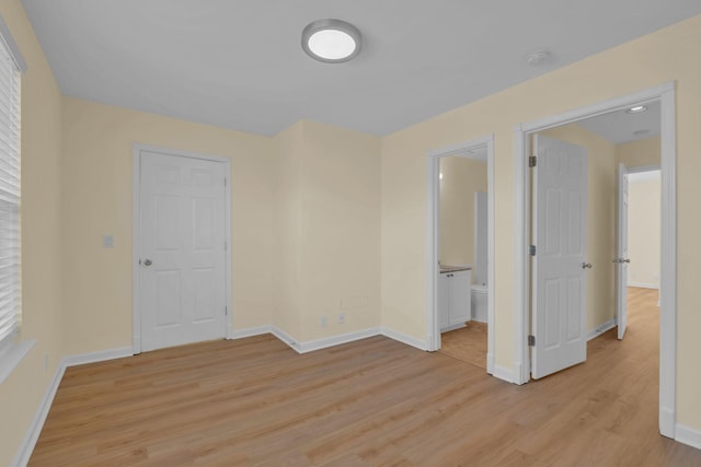 empty room with light hardwood / wood-style flooring