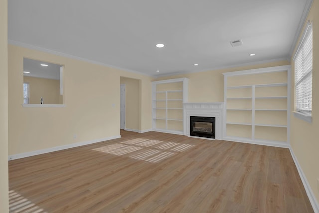 unfurnished living room with ornamental molding, light hardwood / wood-style floors, and built in features