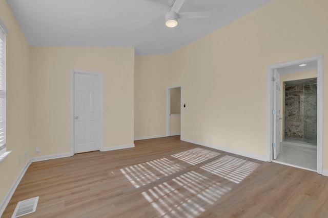 unfurnished room with lofted ceiling and light hardwood / wood-style flooring