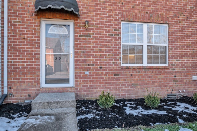 view of snow covered property entrance