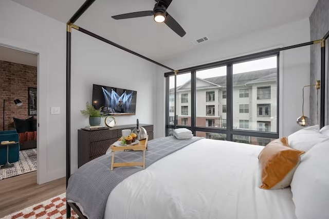 bedroom with hardwood / wood-style floors and ceiling fan