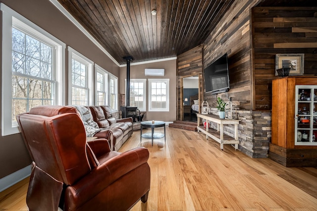 living room featuring an AC wall unit, lofted ceiling, a wood stove, wood ceiling, and light hardwood / wood-style flooring