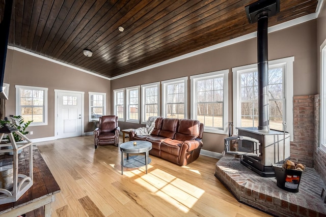 sunroom / solarium featuring wood ceiling, vaulted ceiling, and a wood stove