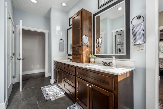 bathroom with vanity and a textured ceiling