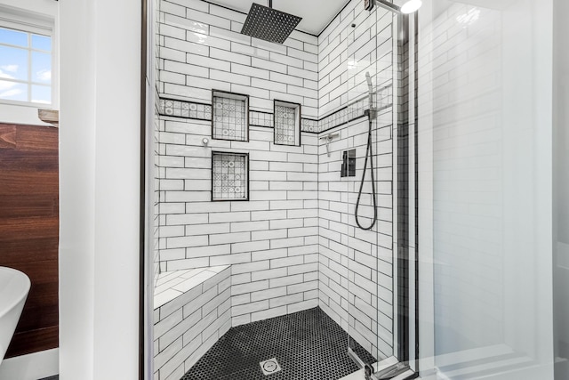 bathroom featuring a shower with shower door