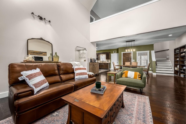 living room featuring dark wood-type flooring and a towering ceiling