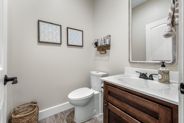 bathroom featuring vanity, hardwood / wood-style floors, and toilet