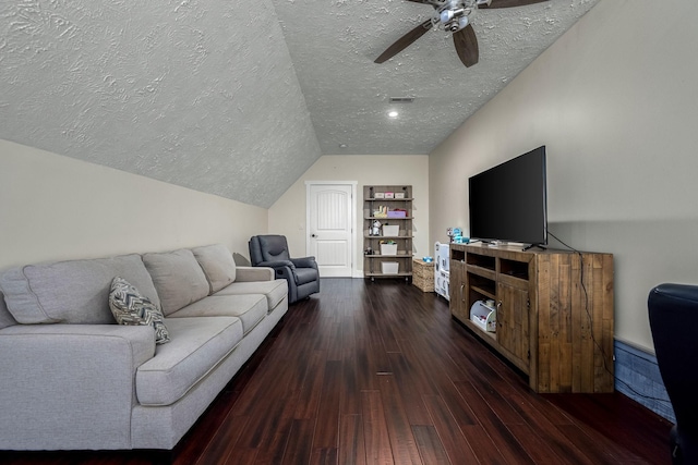 living room featuring vaulted ceiling, ceiling fan, a textured ceiling, and dark hardwood / wood-style flooring