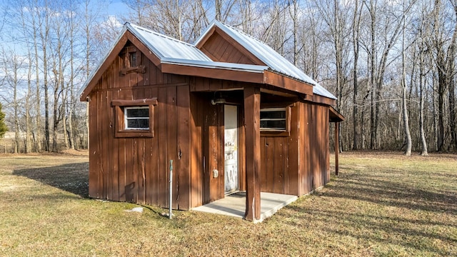 view of outbuilding with a yard