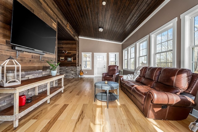 living room with wood ceiling, light wood-type flooring, ornamental molding, vaulted ceiling, and wood walls