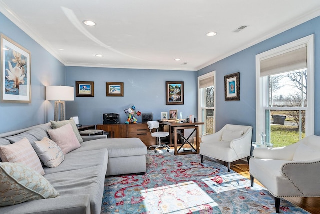 living room with crown molding and light hardwood / wood-style flooring