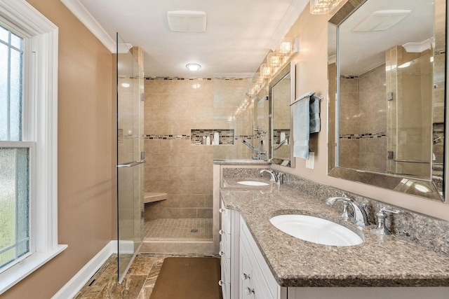 bathroom featuring a shower with door, ornamental molding, and vanity