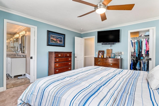 bedroom with ceiling fan, ensuite bathroom, light carpet, a spacious closet, and a closet