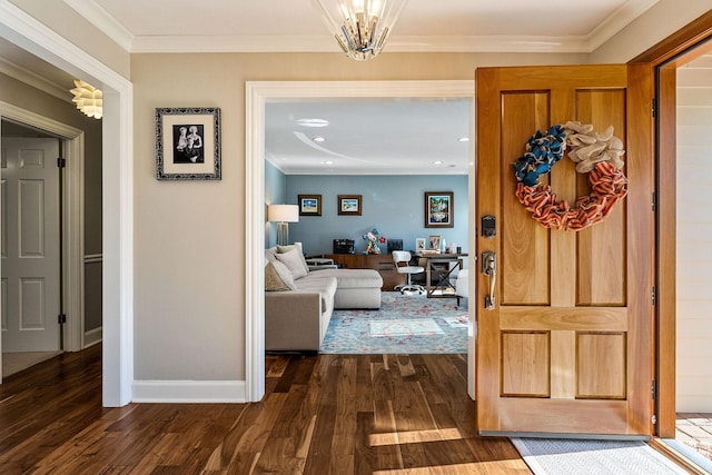 entryway featuring ornamental molding, dark hardwood / wood-style floors, and a chandelier