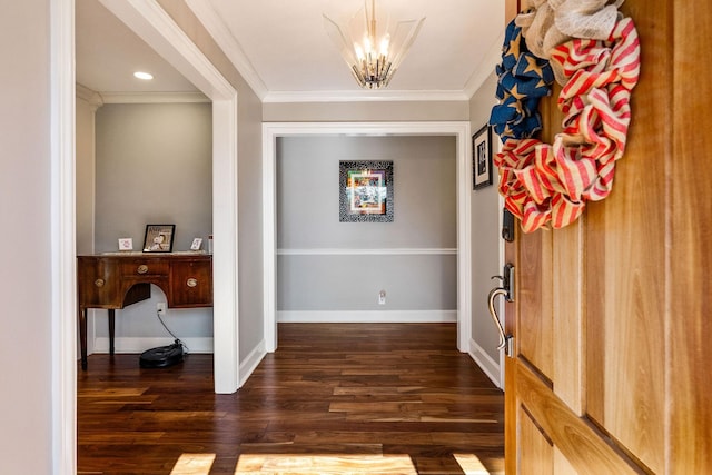 foyer featuring crown molding, dark wood-type flooring, and a chandelier