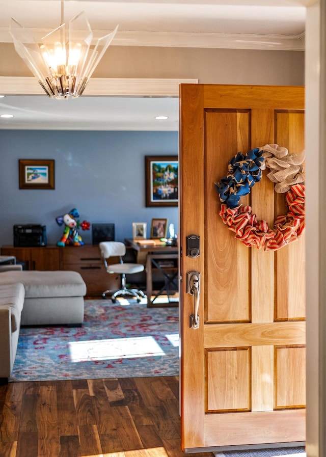 interior space featuring crown molding, dark hardwood / wood-style floors, and a chandelier