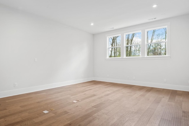 spare room with light hardwood / wood-style floors