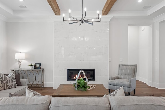 living room featuring hardwood / wood-style floors, a fireplace, and beamed ceiling