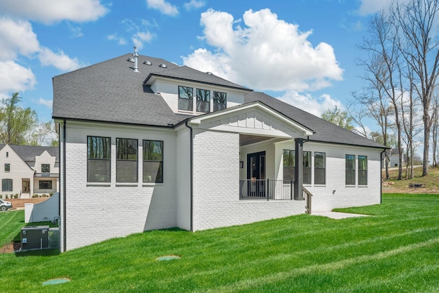 rear view of house featuring a lawn