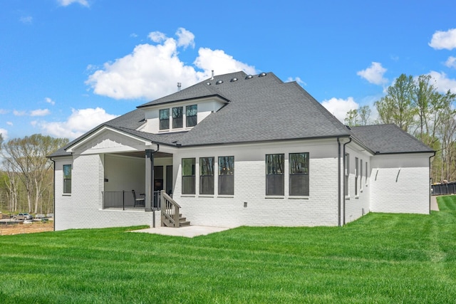 back of house featuring a yard and a patio area