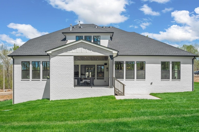 rear view of house with a lawn and a patio area