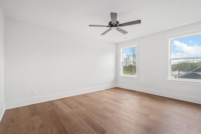 empty room with ceiling fan and wood-type flooring