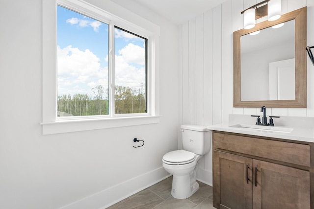 bathroom featuring vanity, tile patterned flooring, and toilet