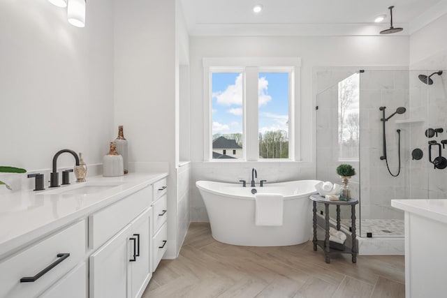 bathroom with crown molding, vanity, and separate shower and tub