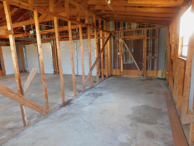 miscellaneous room featuring concrete flooring and lofted ceiling