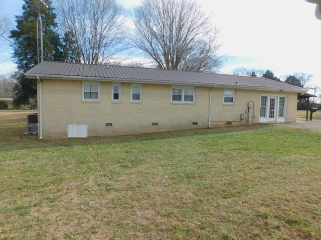 back of property featuring a yard