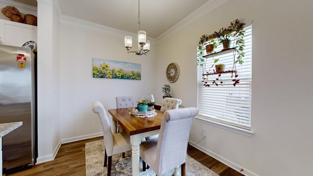 dining room with crown molding, dark hardwood / wood-style floors, and a notable chandelier