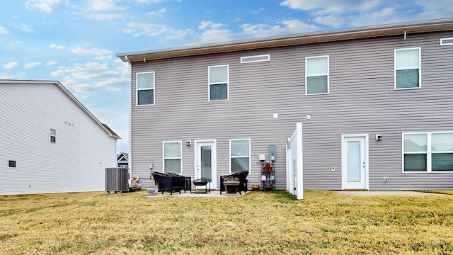 back of house with a patio, a yard, and central air condition unit