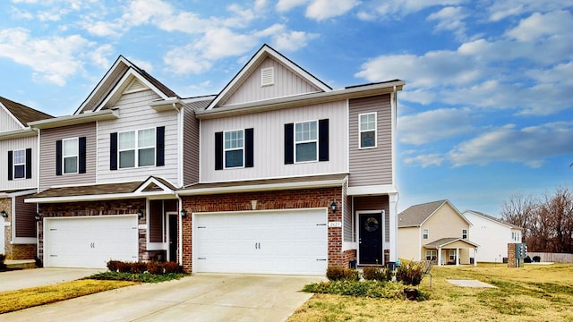 townhome / multi-family property featuring a garage and a front lawn